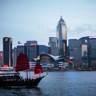 A junk sails on Victoria Harbour in front of the city's skyline in Hong Kong on June 3, 2013. The harbour waters is mostly crowded and often see high-speed hydrofoils vying for space with tourist junks, luxury yachts and a century-old public ferry system that connect Hong Kong island to the Kowloon peninsula. 