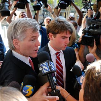 Former Virginia Gov. Bob McDonnell arrives at Federal Court with his son, Bobby, right, for the third day of jury deliberations in his corruption trial in Richmond, Va., Thursday, Sept. 4, 2014. (AP Photo/Steve Helber)