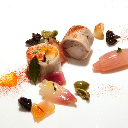 Stuffed rabbit loin poached in saffron vinaigrette with paprika, prunes, and green olive.