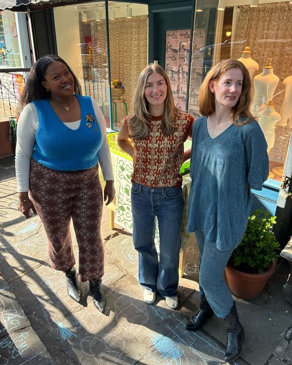 Three women stand outside Misha & Puff's Brooklyn retail store during the brand's sample sale. 