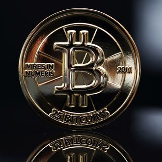 A twenty-five bitcoin is arranged for a photograph in Tokyo, Japan, on Thursday, April 25, 2013. The digital currency, which carries the unofficial ticker symbol of BTC, was unveiled in 2009 by an unidentified programmer, or group of programmers, under the name of Satoshi Nakamoto. Supply is capped at 21 million Bitcoins and managed by a software algorithm embedded into the digital currencys design, rather than a monetary authority such as a central bank. 