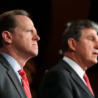 WASHINGTON, DC - APRIL 10: Sen. Pat Toomey (R-PA) (L) and Sen. Joe Manchin (D-WV) speak to the press about background checks for gun purchases, in the U.S. Capitol building April 10, 2013 in Washington DC. The pair is proposing a bipartisan compromise, a proposal to be voted on as an amendment that would expand background checks to firearms sales at gun shows and on the Internet. (Photo by Allison Shelley/Getty Images)