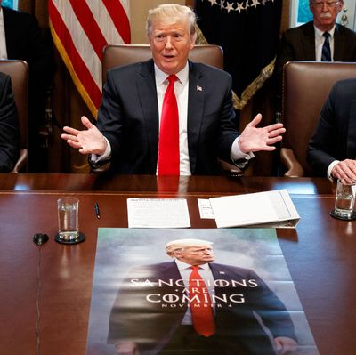 President Donald Trump in front of the meme poster.