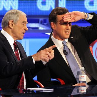 MESA, AZ - FEBRUARY 22: Republican presidential candidates (L-R) U.S. Rep. Ron Paul (R-TX), and former U.S. Sen. Rick Santorum talk during a commercial break as they participate in a debate sponsored by CNN and the Republican Party of Arizona at the Mesa Arts Center February 22, 2012 in Mesa, Arizona. The debate is the last one scheduled before voters head to the polls in Michigan and Arizona's primaries on February 28 and Super Tuesday on March 6. (Photo by Justin Sullivan/Getty Images)