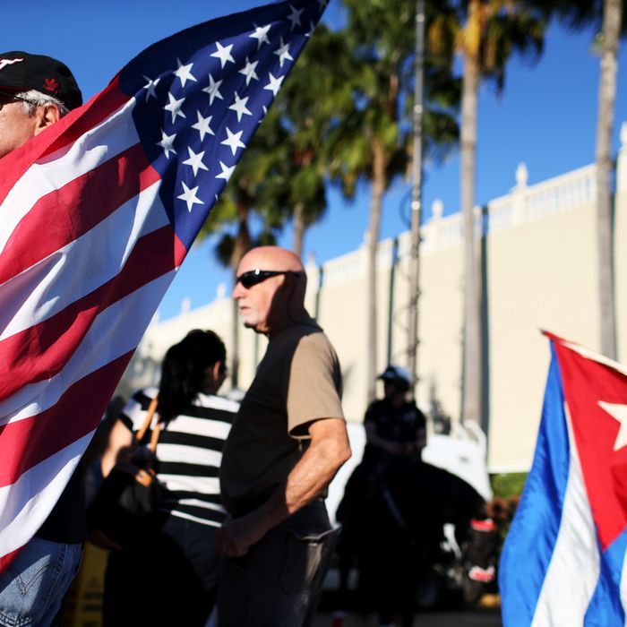 People stand outside the Little Havana restaurant Versailles after U.S. President Barack Obama's announcement on United States-Cuba policy change on December 17, 2014 in Miami, Florida.