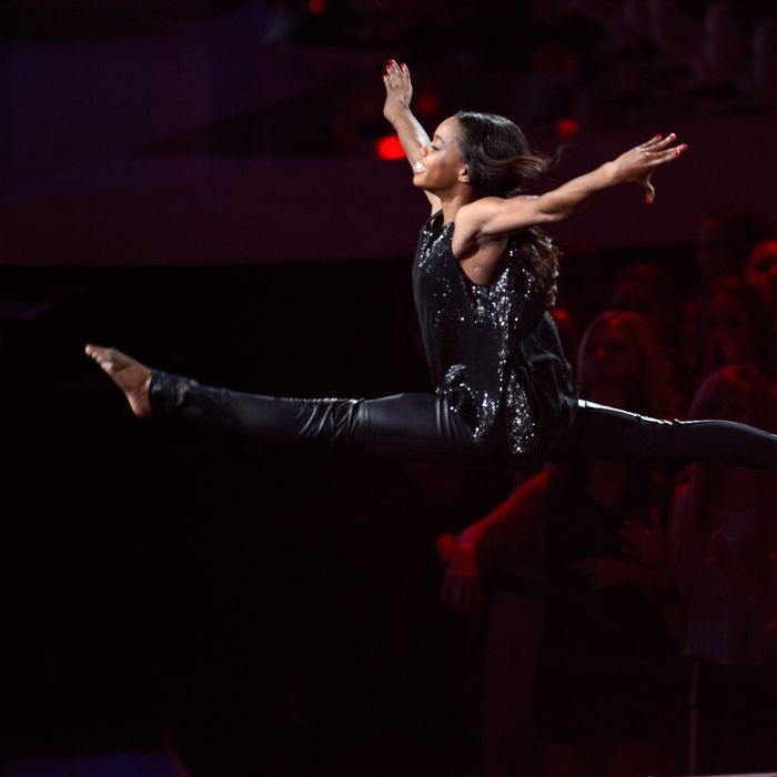 Gabby Douglas performs onstage while Alicia Keys sings during the 2012 MTV Video Music Awards at Staples Center on September 6, 2012 in Los Angeles, California.