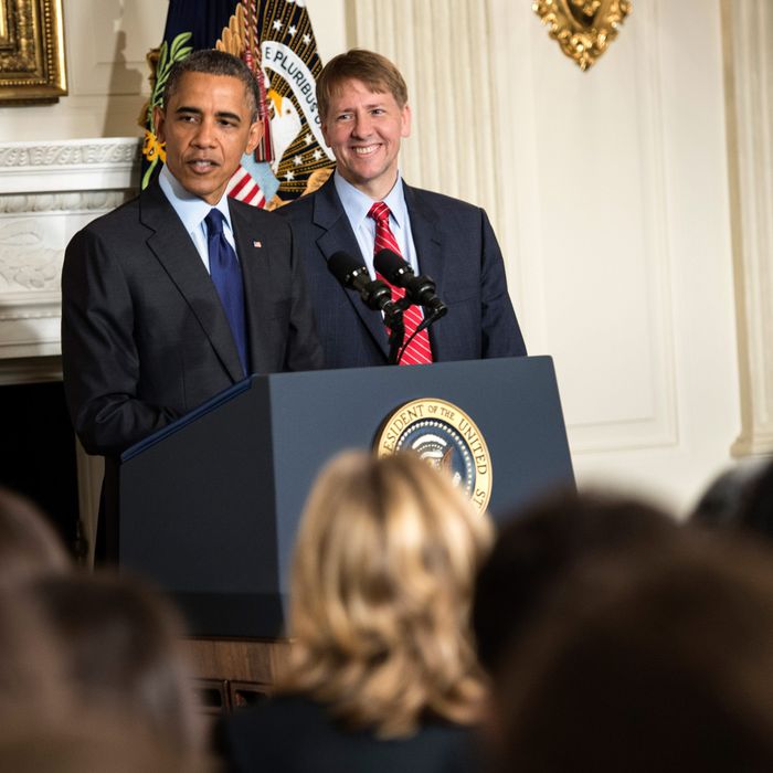 Consumer Financial Protection Bureau Director Richard Cordray listens to US President Barack Obama make a statement in the State Dining Room of the White House July 17, 2013 in Washington, DC. Obama spoke about the recent confirmation of Cordray as the Director of the Consumer Financial Protection Bureau, who was sworn in earlier today.
