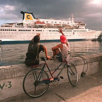 Havana residents wave to tourists arriving