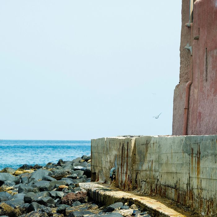 US President Barack Obama looks out from the Door of No Return while touring the House of Slaves, or Maison des Esclaves, at Goree Island off the coast of Dakar on June 27, 2013. Obama and his family toured the museum at the site where African slaves were held before going through the door and being shipped off the continent as slaves. 