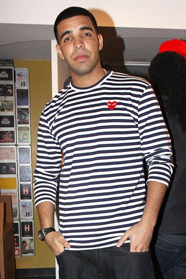 The sweater and/or label enthusiast will recognize the googly-eyed red heart on Drake's chest as the logo for Japanese fashion house Comme des Garçons PLAY. Drake, as we will see, is a devoted CDG fan — a collector, you might say, since a fine sweater is in its own way a piece of art. Here, he sports a timeless nautical-stripe crewneck that brings a hint of French New Wave to an otherwise dreary red carpet. Its pattern and material blur the lines between masculine and feminine, shirt and sweater.