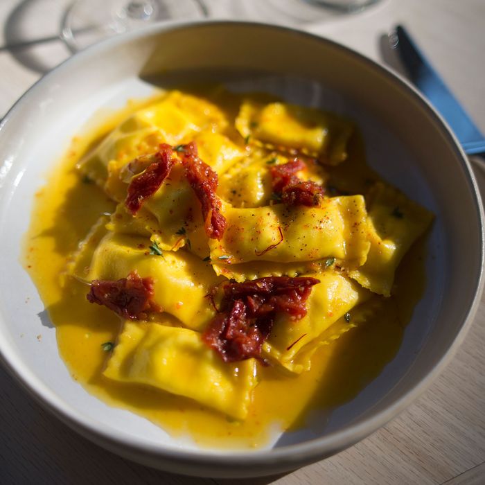 Sheep's-milk-cheese-filled pasta with saffron, tomato sugo, and honey.