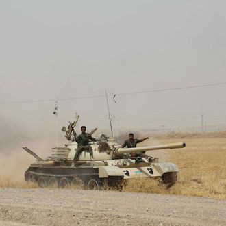 Kurdish Peshmerga forces and Iraqi special forces deploy their troops and armoured vehicles outside of the oil-rich city of Kirkuk, Iraq on June 12, 2014. The hardline militant group, Islamic State of Iraq and the Levant (ISIL), have taken control of the northern Iraqi city of Mosul on Tuesday, headed south and attacked parts of the city of Kirkuk and Tikrit on Wednesday. 