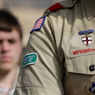 The Boy Scouts uniform fashioned with an Quality patch is on the arm of Brad Hankins, a campaign director for Scouts for Equality, as he responds to questions during a news conference in front of the Boy Scouts of America headquarters Monday, Feb. 4, 2013, in Dallas, Texas. Scouts and their families have delivered a petition to the Boy Scouts of America headquarters urging an end to a policy banning gay scouts and leaders from the organization. (AP Photo/Tony Gutierrez)