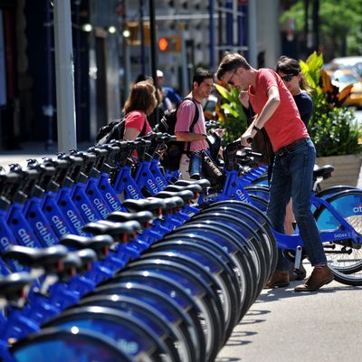 A couple get their Citi Bike bicycles from a station near Union Square as the bike sharing system is launched May 27, 2013 in New York. About 330 stations in Manhattan and Brooklyn will have thousands of bicycles for rent.