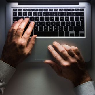 Laptop computer with man's hands