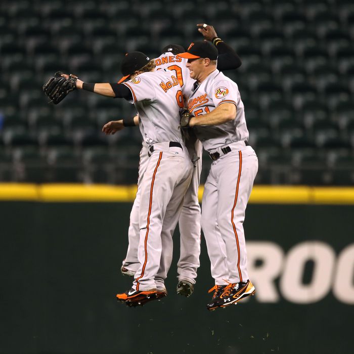 Outfielders Nate McLouth #9, Adam Jones #10, and Lew Ford #51 of the Baltimore Orioles celebrate after defeating the Seattle Mariners 4-2 in eighteen innings at Safeco Field on September 18, 2012 in Seattle, Washington. 