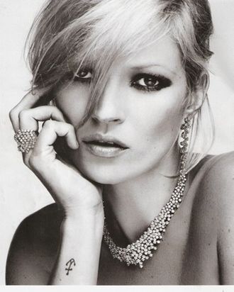 Kate Moss models her new jewelry.
