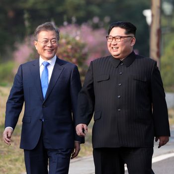 North Korea's leader Kim Jong Un (R) and South Korea's President Moon Jae-in (L) walk together after a tree-planting ceremony at the truce village of Panmunjom on April 27, 2018. - The leaders of the two Koreas held a landmark summit on April 27 after a highly symbolic handshake over the Military Demarcation Line that divides their countries, with the North's Kim Jong Un declaring they were at the 'threshold of a new history'.