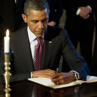 US President Barack Obama signs a book of condolences at the Norwegian Ambassador's residence in Washington, DC, July 26, 2011. Obama visited the residence of the Norwegian ambassador on Tuesday to personally offer his condolences after 76 people died in twin attacks. AFP PHOTO/Jim WATSON (Photo credit should read JIM WATSON/AFP/Getty Images)