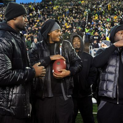 EUGENE, OR - NOVEMBER 19: (L to R) LeBron James, Carmelo Anthony and Dwyane Wade play around on the sidelines before the game between the Oregon Ducks and the USC Trojans at Autzen Stadium on November 19, 2011 in Eugene, Oregon. (Photo by Steve Dykes/Getty Images)