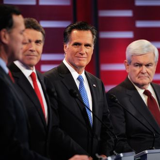 Mitt Romney (C) former speaker of the House Newt Gingrich (R) during the ABC News GOP Presidential debate on the campus of Drake University on December 10, 2011 in Des Moines, Iowa.