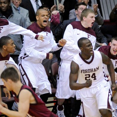 Fordham players celebrate after Bryan Smith (24) hit a 3-point shot during the second half of an NCAA college basketball game against Harvard on Tuesday, Jan. 3, 2012.