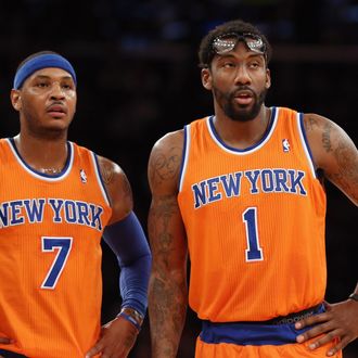 Carmelo Anthony #7 and Amar'e Stoudemire #1 of the New York Knicks wait for play to resume during the second quarter against the Boston Celtics at Madison Square Garden on December 8, 2013 in New York City.