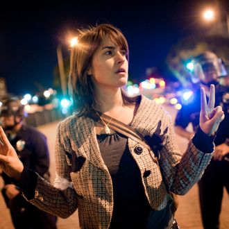  A member of Occupy LA protests on the street in front of City Hall in downtown on November 28, 2011.