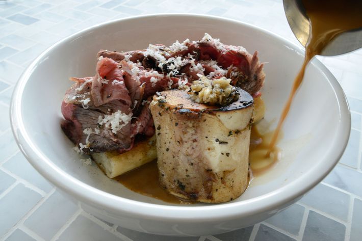 A French dip of beef deckle on bagna-cauda-griddled baguette, served with marrow, horseradish, and black-garlic beef jus.