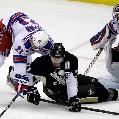 Pittsburgh Penguins' Evgeni Malkin (71) collides with New York Rangers' Derek Stepan (21) in front of goalie Henrik Lundqvist during the first period of an NHL hockey game in Pittsburgh, Tuesday, Feb. 21, 2012. 