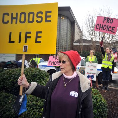 People supporting and opposing abortion demonstrate outside of the Alabama Women's Center for Reproductive Alternatives in Huntsville, Ala., Saturday, Feb. 23, 2013, during a 