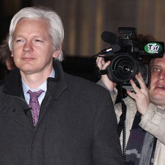Julian Assange (L), the founder of the WikiLeaks whistle-blowing website, leaves the Supreme Court on February 02, 2012 in London, England.