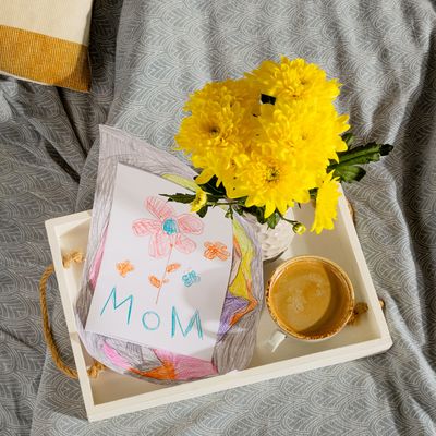 A gift from a child for mothers day - a card from a picture and coffee in bed in the morning
