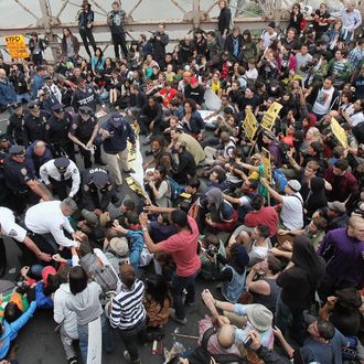 NEW YORK, NY - OCTOBER 01: Police arrest demonstrators affiliated with the Occupy Wall Street movement after attempting to cross the Brooklyn Bridge on the motorway on October 1, 2011 New York City. The highway is not intended for pedestrians, the marchers attempted to cross the bridge on the highway and were stopped on the middle of the bridge by police. Police were in the process of arresting hundreds of the protesters on the bridge. Occupy Wall Street demonstrators are opposed to outsized corporate profits on Wall Street.. (Photo by Mario Tama/Getty Images)