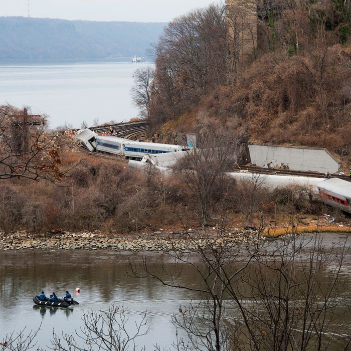 Emergency workers respond to the scene of a Metro-North commuter train derailment just north of the Spuyten Duyvil station December 1, 2013 in the Bronx borough of New York City. Multiple injuries and at least 4 deaths were reported after the seven car train left the tracks as it was heading to Grand Central Terminal along the Hudson River line. 