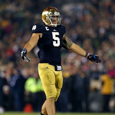 Manti T'eo #5 of the Notre Dame Fighting Irish encourages the crowd to cheer during a game against the Wake Forest Demon Deacons at Notre Dame Stadium on November 17, 2012 in South Bend, Indiana. Notre Dame defeated Wake Forest 38-0.