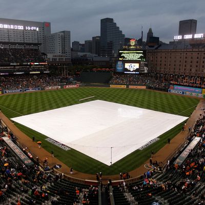 The tarp is seen on the field prior to the Baltimore Orioles hosting the New York Yankees during Game One of the American League Division Series at Oriole Park at Camden Yards on October 7, 2012 in Baltimore, Maryland.