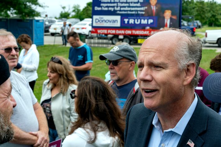 Incumbent Rep. Dan Donovan speaks to supporters and participants as he attends a property tax protest rally in the Staten Island on Saturday, June 23, 2018. In the background is a campaign billboard advertising President Trump's endorsement on Donovan.