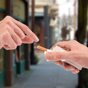 offering a cigarette from the pack on the street