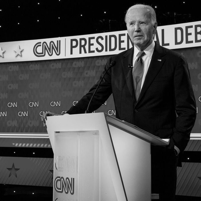 Donald Trump stands at a podium to the left of the CNN debate stage while Joe Biden stands at a podium to the right.