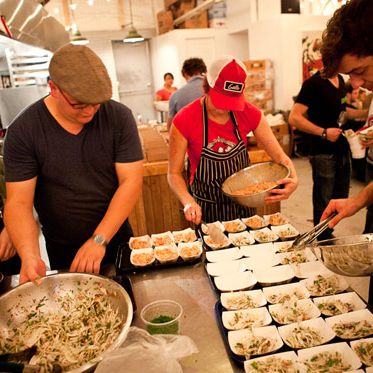 The M. Wells and Grumman '78 crews plate the fennel salad with salmon crudo.
