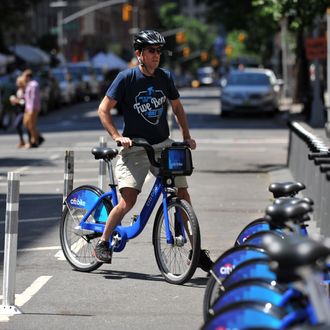 A man returns his Citi Bike bicycle to a station near Union Square as the bike sharing system is launched May 27, 2013 in New York. About 330 stations in Manhattan and Brooklyn will have thousands of bicycles for rent. 