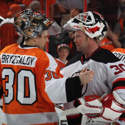 Ilya Bryzgalov #30 of the Philadelphia Flyers and Martin Brodeur #30 of the New Jersey Devils shake hands following the Devils victory over the Philadelphia Flyers in Game Five of the Eastern Conference Semifinals during the 2012 NHL Stanley Cup Playoffs at Wells Fargo Center on May 8, 2012 in Philadelphia, Pennsylvania. The Devils defeated the Flyers 3-1 to win the series four games to one.