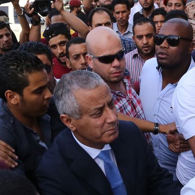 Libyan Prime Minister Ali Zeidan (C) arrives at the government headquarters in Tripoli on October 10, 2013 shortly after he was freed from the captivity of militiamen who had held him for several hours. Gunmen seized Zeidan from a hotel, where he resides, in the Libyan capital and held him for several hours before he was freed, in the latest sign of Libya's lawlessness since Moamer Kadhafi was toppled in 2011. 