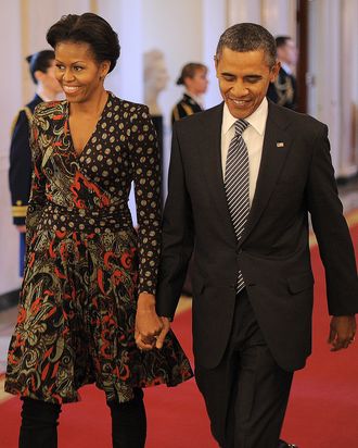 US President Barack Obama and First Lady Michelle Obama arrive to present the 2011 National Medal of Arts and Humanities Medal in the East Room at the White House in Washington, DC, on February 13, 2012.