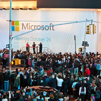 Kevin Turner, chief operating officer of Microsoft Corp., stage right, Panos Panay, general manager of Microsoft Surface, center, and Melinda George, Times Square store manager, attend the Microsoft Corp. store grand opening in New York, U.S., on Thursday, Oct. 25, 2012. Microsoft Corp. introduced the biggest overhaul of its flagship Windows software in two decades, reflecting the rising stakes in its competition with Apple Inc. and Google Inc. for the loyalty of customers who are shunning personal computers and flocking to mobile devices.