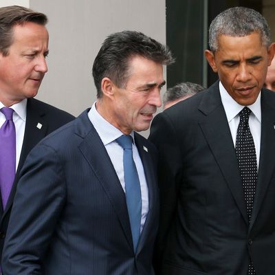 US President Barack Obama (R), NATO Secretary General Anders Fogh Rasmussen (C) and British Prime Minister David Cameron (L) arrive for the family photo at the start of the NATO 2014 summit in Newport, South Wales, on September 4, 2014. The NATO summit billed as the most important since the Cold War got underway Thursday with calls to stand up to Russia over Ukraine and confront Islamic State extremists. 