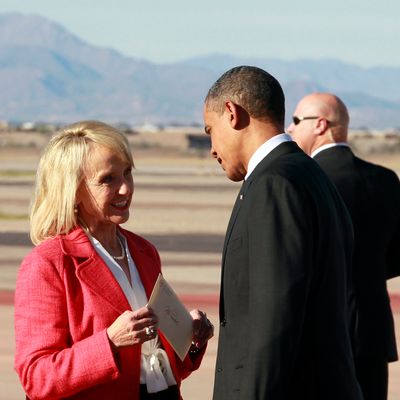 President Barack Obama talks with Arizona Gov. Jan Brewer after arriving at Phoenix-Mesa Gateway Airport, Wednesday, Jan. 25, 2012, in Mesa, Ariz.