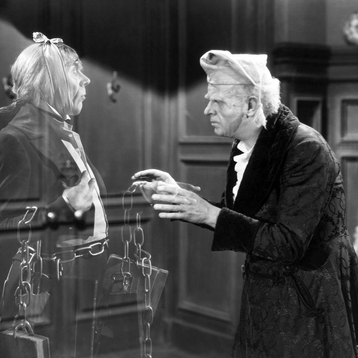 Reginald Owen, playing Scrooge, speaks with his dead business partner Marley, played by Leo G. Carroll, during the 1938 MGM production of 