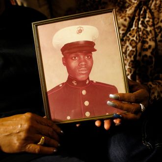 FILE - In this March 12, 2014, file photo, a picture of Jerome Murdough is held by his mother and sister in the Queens borough of New York. Murdough, a 56-year-old mentally ill inmate at Rikers Island jail, 